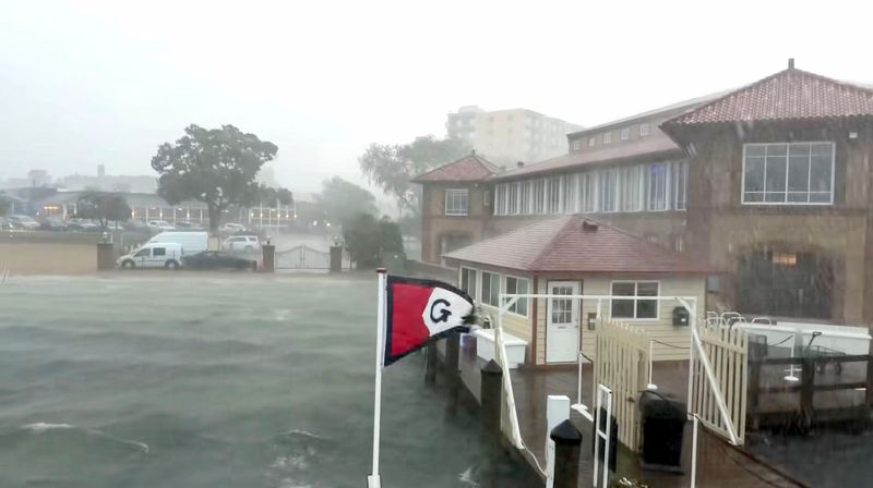 A photo from a video shows a powerful storm sweeping across Lake Geneva, forcing mailboat passengers to rush for safety. The rapidly developing storm created hazardous boating conditions on Geneva Lake, overwhelming a recreational boat carrying 10 people and causing it to capsize and sink. Three children died, according to the Geneva Lake Law Enforcement Agency, while six adults and one child were rescued.