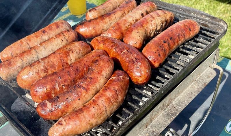 Bratwurst is a mainstay on grills among the tailgaters outside Lambeau Field on game days.