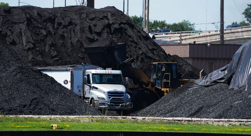 The coal piles at C. Reiss Coal Co. seen along the Fox River pictured on July 6, 2026, in Green Bay, Wis.