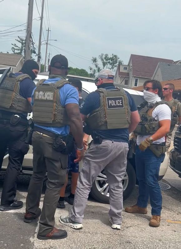 Several ICE agents arrest an individual on South 27th Street and West Lincoln Avenue in Milwaukee.