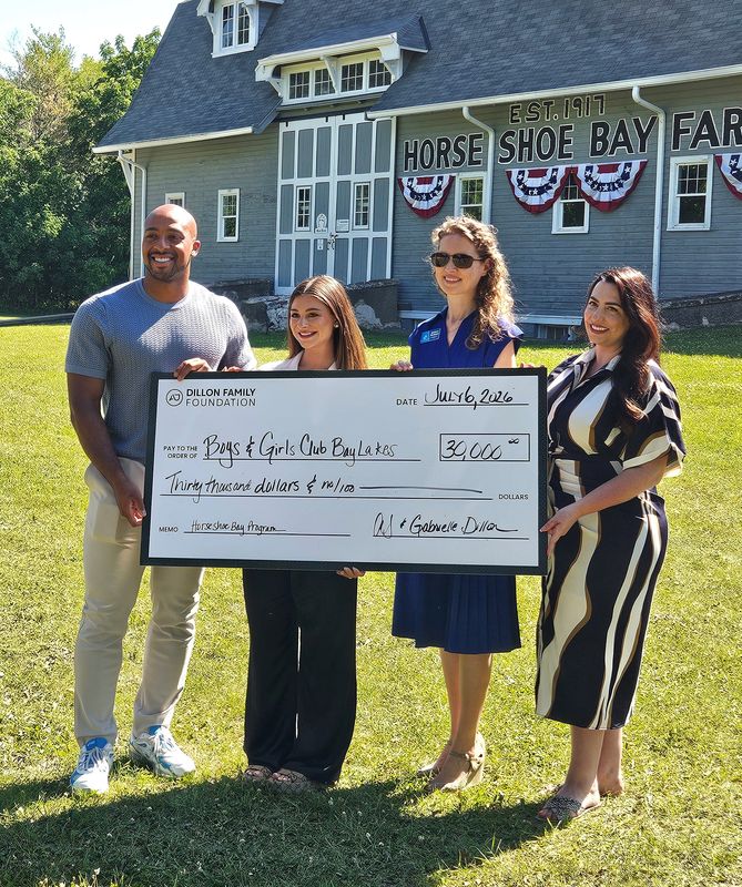 Former Green Bay Packers player AJ Dillon and his wife, Gabrielle, left, presented a $30,000 donation to the Boys & Girls Clubs of the Bay & Lakes Region, which includes the Boys & Girls Club of Door County, during a July 1 event at Horseshoe Bay Farms in Egg Harbor. Accepting the donation are Boys & Girls Clubs of the Bay & Lakes Region CEO Johanna Wicklund, second from right, and Boys & Girls Club of Door County development director Kacie Mueller, right. The donation included $15,000 from the couple's Dillon Family Foundation.