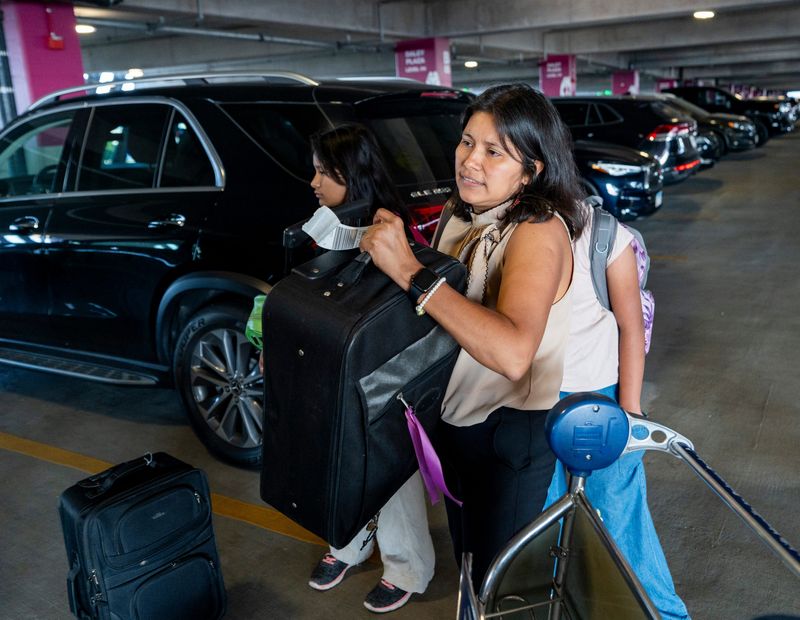 Yessenia Ruano, a former Milwaukee teacher's aide who drew the city's attention while fighting her deportation, loads suitcases into a car outside Terminal 5 at Chicago O'Hare International Airport after returning to the United States following a year in El Salvador in Chicago, Illinois on July 7, 2026.