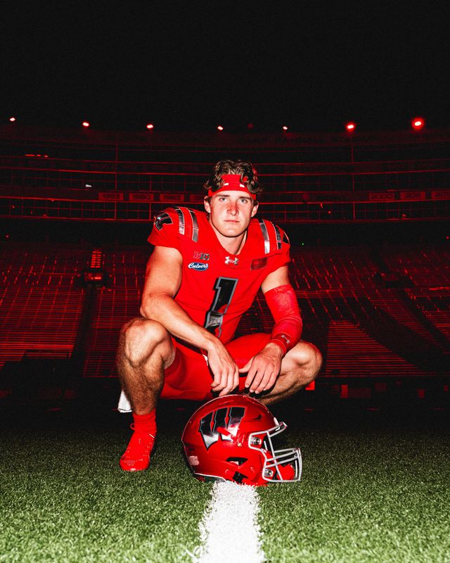 Wisconsin quarterback Colton Joseph models the Badgers' alternate uniforms that they will wear for the Sept. 6 game against Notre Dame.