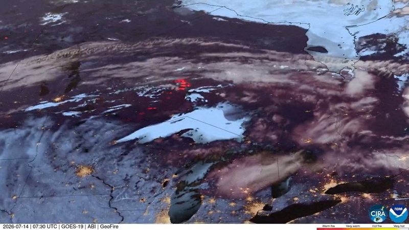 A satellite image shows wildfires spreading through northern Minnesota, U.S., and Ontario, Canada, July 14, 2026.