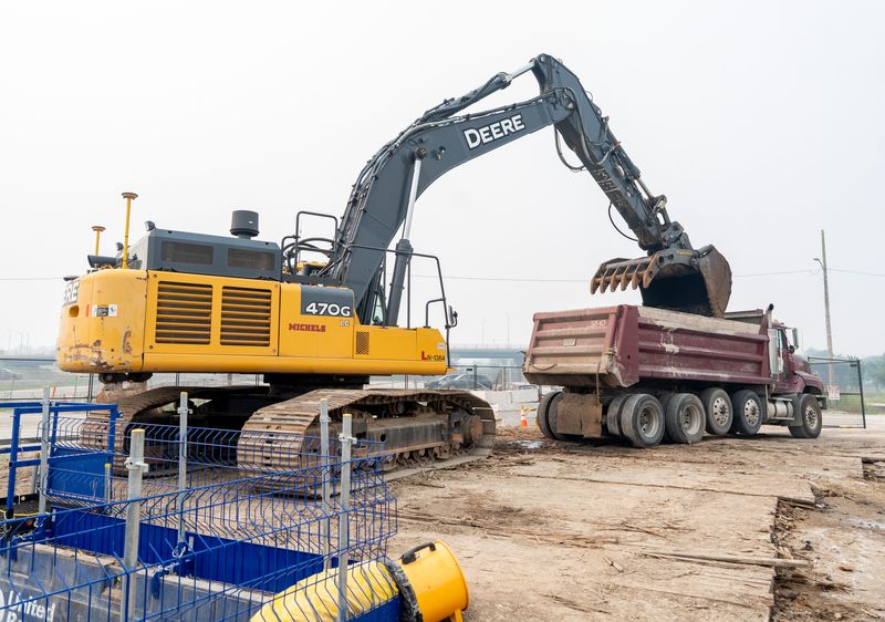 A Michels labor worker uses an excavator to clear a blockage in a combined sewer overflow pipe underground near South Carferry Drive in Milwaukee, Wisconsin on July 16, 2026. The Milwaukee Metropolitan Sewerage District said a combined sewer overflow pipe has a significant blockage upstream of its outlet to the lake. The clog was made up of woody debris, including branches, limbs and tree trunks, along with plastic trash.