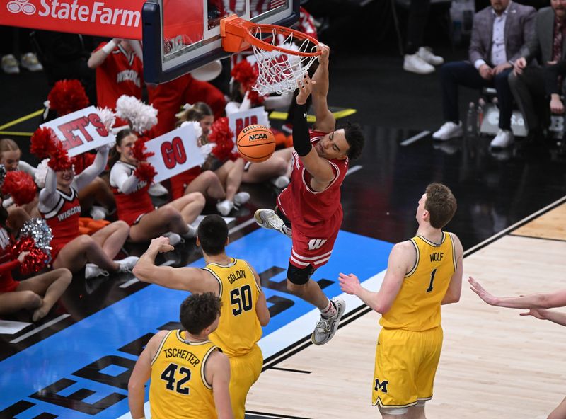 Mar 16, 2025; Indianapolis, IN, USA; Wisconsin Badgers guard John Tonje (9) dunks past Michigan Wolverines center Vladislav Goldin (50) during the second half during the 2025 Big Ten Championship Game at Gainbridge Fieldhouse. Mandatory Credit: Robert Goddin-Imagn Images