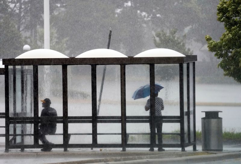 Milwaukee County Transit passengers take shelter during late morning thunderstorms in Wauwatosa, Wisconsin on July 27, 2026 at the Mayfair Mall. The much needed rain could possibly return in the late afternoon producing severe weather conditions including hail and strong winds.