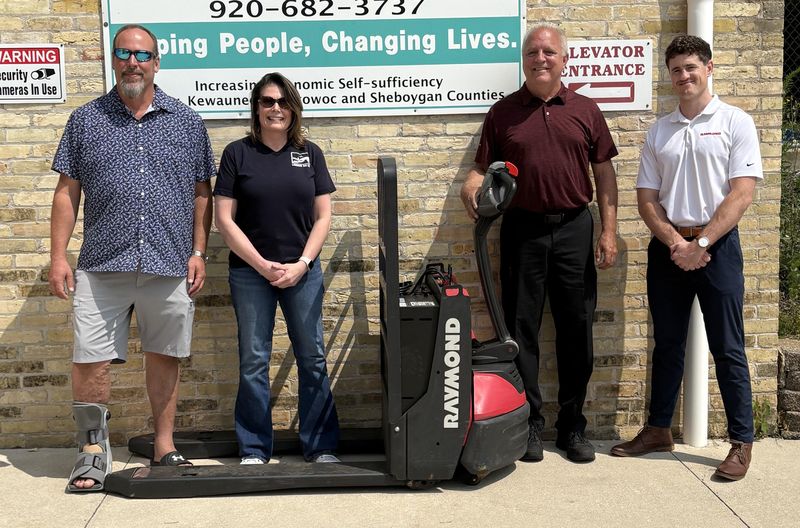 Pictured, from left, are Randy Rosinsky, Tera Winnekens, Kurt Kozak and Kollyn Beyer with the electric pallet jack donated by Associated Solutions to Lakeshore CAP.
