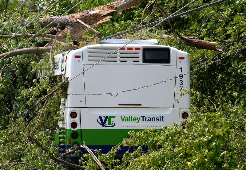 A Valley Transit bus is seen tangled in power lines and tree branches along West Spencer Street on the Southwest side of Appleton, Wisconsin on July 28, 2026 after an estimated EF-3 tornado tore through the area on July 27.
