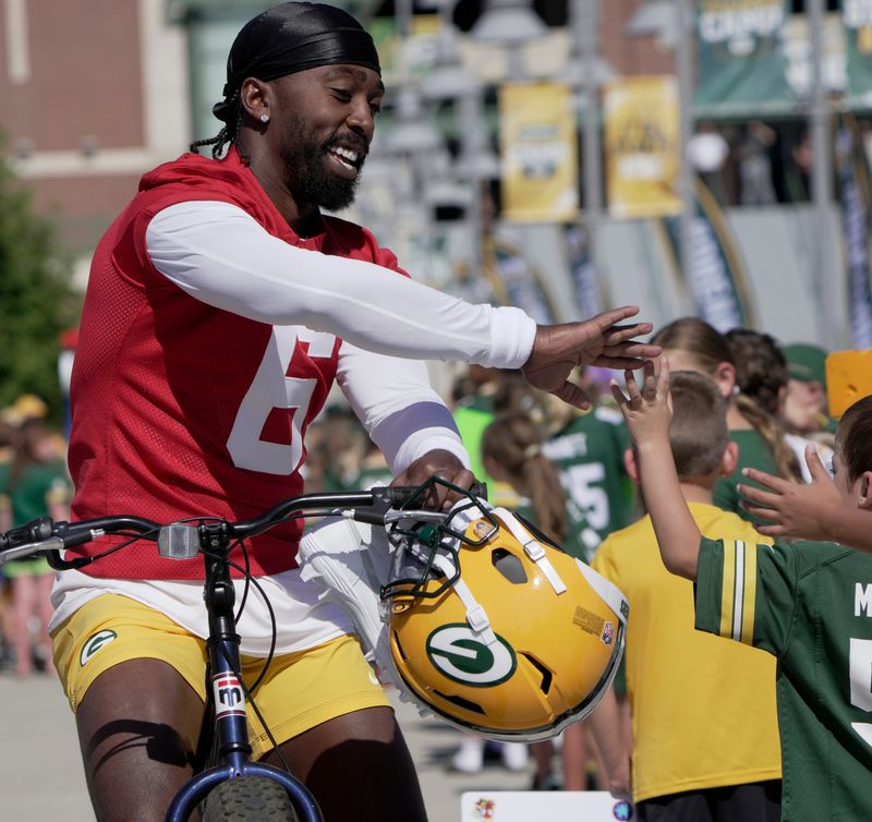 Green Bay Packers backup quarterback Tyrod Taylor greets fans during the team's first training camp practice on July 29. Just two weeks earlier, Taylor got married his fiancée Bianka Charity-Parker.
