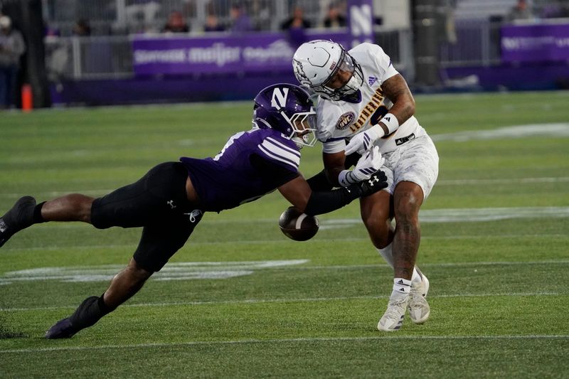 Sep 5, 2025; Evanston, Illinois, USA; Northwestern Wildcats defensive back Dillon Tatum (8) defends Western Illinois Leathernecks wide receiver Eric Denham (0) during the first half at Northwestern Medicine Field at Martin Stadium. Mandatory Credit: David Banks-Imagn Images