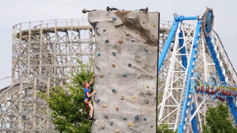 Kids try the climbing wall the City of Green Bay's first Kids' Karnival on July 30, 2026, at Bay Beach Amusement Park in Green Bay, Wis.