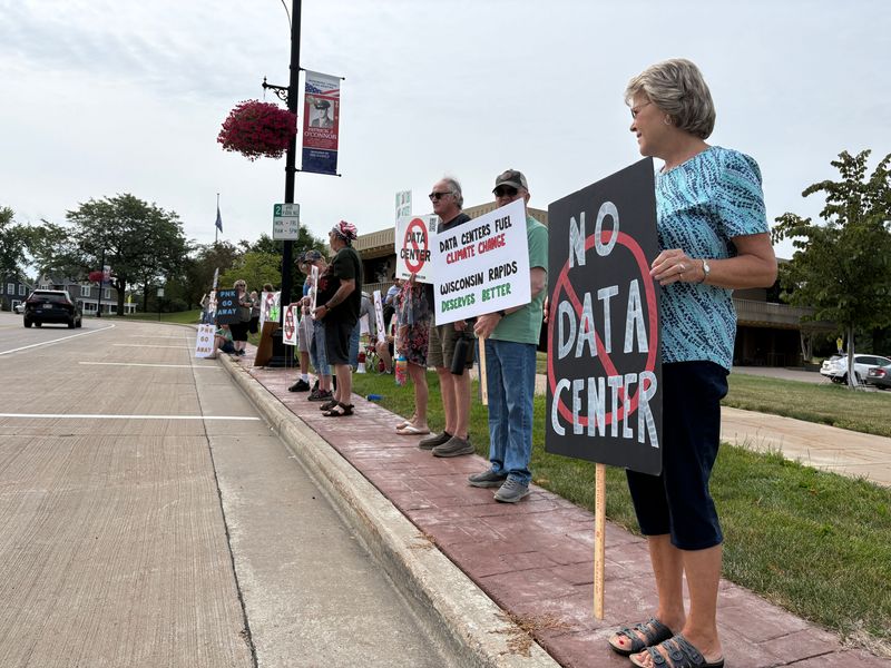 Over 50 people gathered outside of McMillan Memorial Library on Saturday, Aug. 1, 2026, to protest a proposed data center in Wisconsin Rapids. The protest was planned ahead of a public meeting by data center developer PNK Group and former New York City Mayor Eric Adams.