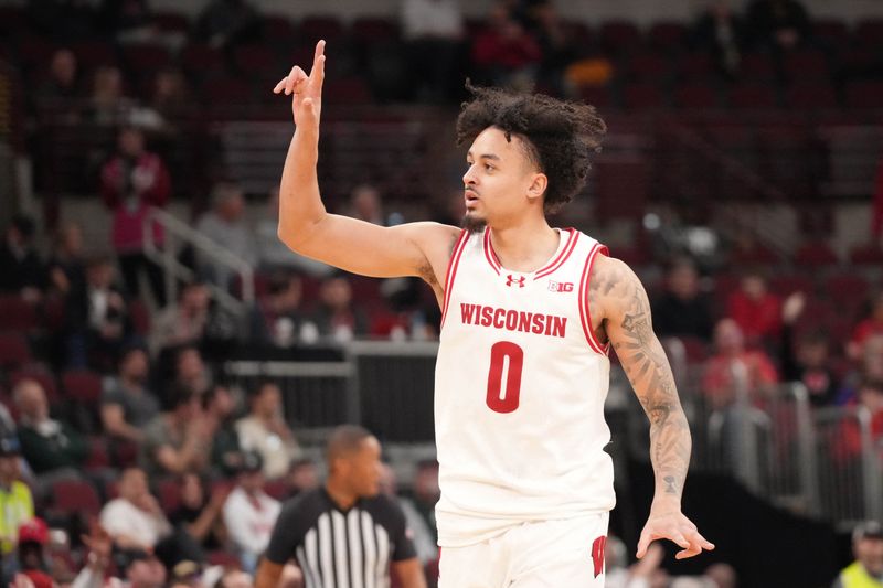 Mar 12, 2026; Chicago, IL, USA; Wisconsin Badgers guard Braeden Carrington (0) celebrates his three point basket against the Washington Huskies during the second half at United Center. Mandatory Credit: David Banks-Imagn Images