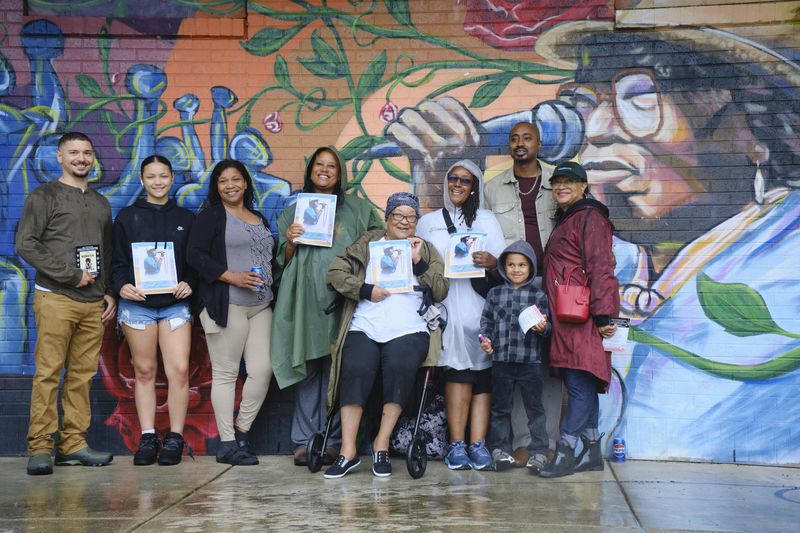 Some of Lucille Berrien's family celebrated her life and legacy at Berrien Park, a city park named after her, in front of a mural depicting her life as a Milwaukee activist and influential figure, especially during the Civil Rights movement and Milwaukee Fair Housing Marches.