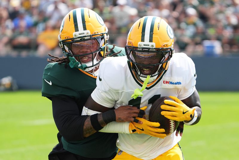 Green Bay Packers nickel cornerback Javon Bullard tries to tackle wide receiver Jayden Reed during the sixth day of training camp.
