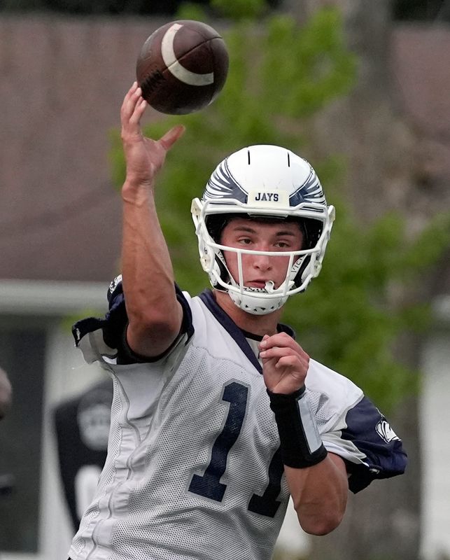 Menasha’s Paul Schmolinske throws a pass during Menasha’s first football practice of the season Aug. 4 at Maplewood middle school in Menasha.