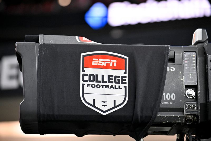 Dec 6, 2025; Arlington, TX, USA; A view of a tv camera and the ESPN college football logo before the game between the Texas Tech Red Raiders and the BYU Cougars at AT&T Stadium. Mandatory Credit: Jerome Miron-Imagn Images