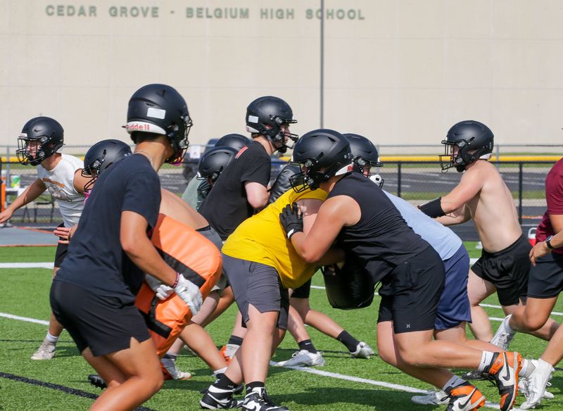 Cedar Grove-Belgium players run a play during football practice, Friday, August 7, 2026, in Cedar Grove, Wis.