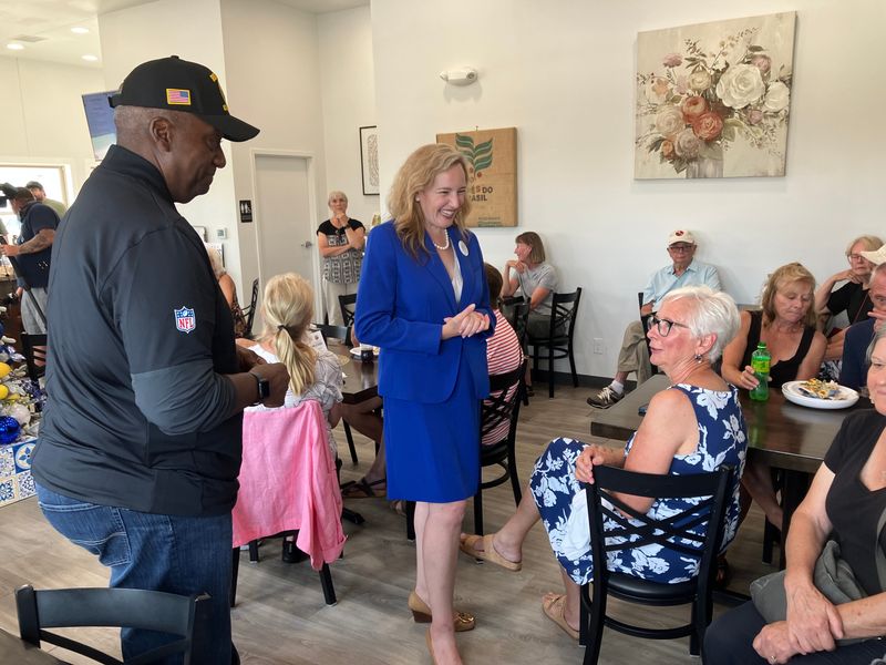 Democratic candidate for the 8th Congressional District Rick Crosson, left, and Democratic gubernatorial candidate Kelda Roys, center, on Aug. 7 talked with voters at Vintage Rose Bakery in De Pere ahead of the Aug. 11 primary election.