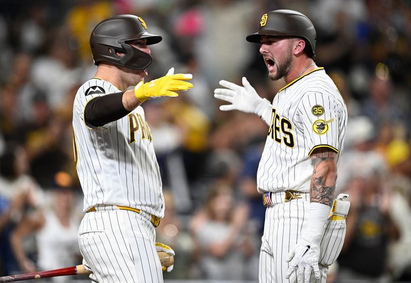Padres center fielder Jackson Merrill, right, is congratulated by designated hitter Gavin Sheets after hitting a two-run home run during the seventh inning of their game against the Brewers on Aug. 10 at Petco Park.