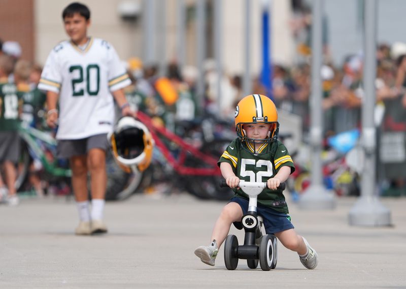A young Green Bay Packers fan participates in the DreamDrive bicycle ride before practice on Aug. 11, 2026, outside Lambeau Field in Green Bay, Wis.
