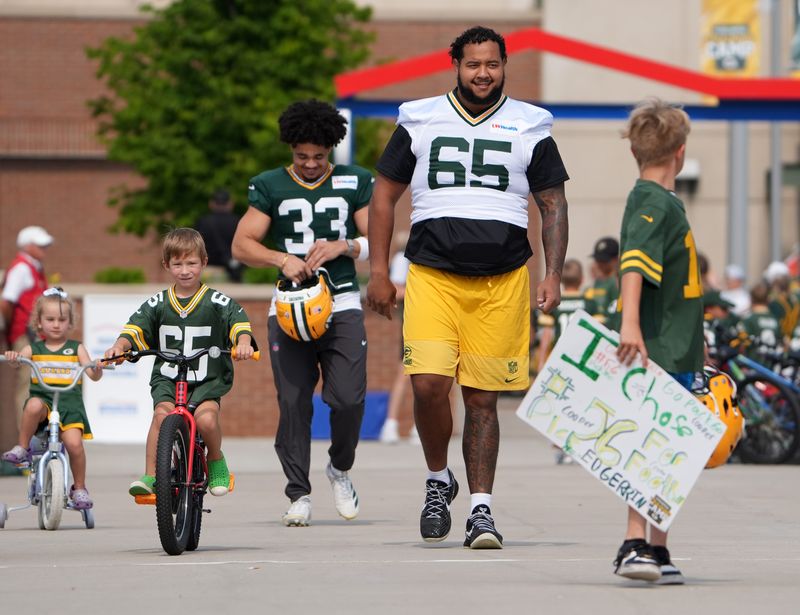 Green Bay Packers guard Aaron Banks participates in the DreamDrive bicycle ride before practice on Aug. 11.