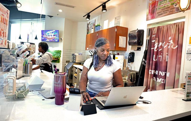 Tana Jeter, right, owner of Cinnabar Nutrition at Sherman Phoenix, works on Aug. 12, 2026, along with Deshanti Gray, left.