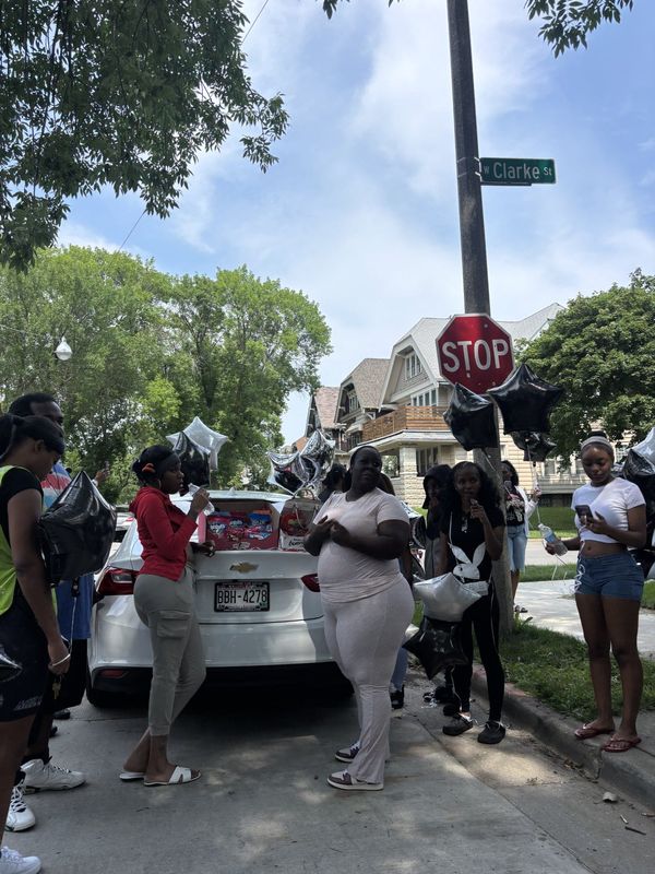 Family members sell candy in honor of Armani Thomas-Cotton, 16, a Milwaukee boy who killed in a drive-by shooting, on Aug. 13.