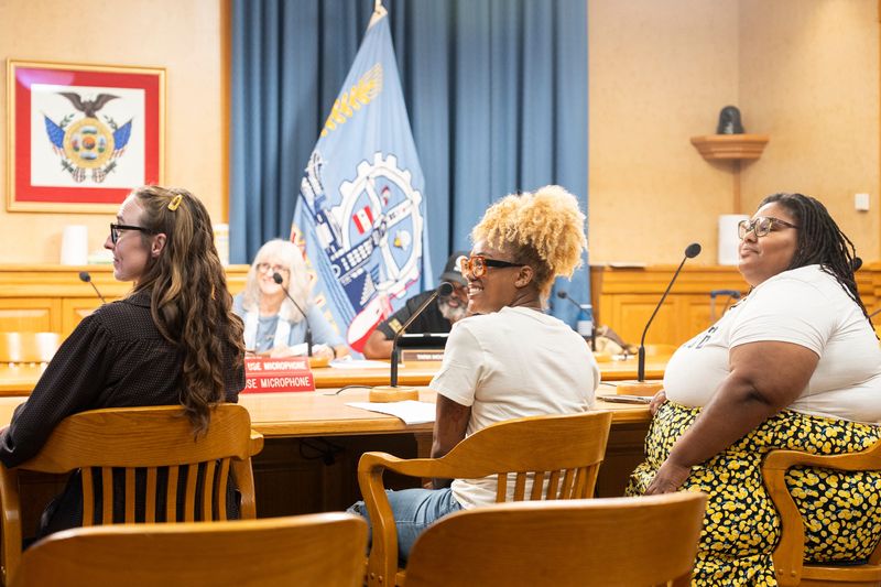 (From left) Sally Svetic, a neighborhood business development specialist, Koren Dennison, a Metcalfe Park resident, and Melody McCurtis, the deputy director & lead organizer of Metcalfe Park Community Bridges, talk about a Neighborhood Improvement District No. 13 proposal for Metcalfe Park during a City Planning Commission at City Hall on Aug. 17, 2026, in Milwaukee, Wisconsin. The proposal was approved by the CPC, and will now be presented to the Community and Economic Development Committee.