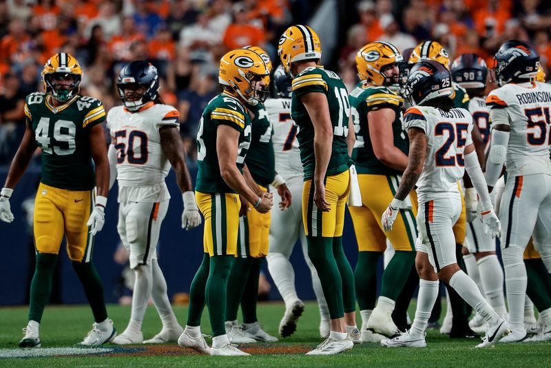 Packers kicker Trey Smack (28) reacts with punter Daniel Whelan (19) after a field goal in the second quarter against the Broncos on Aug. 21 at Empower Field at Mile High.
