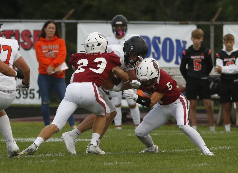 Mayville's Isaiah Gregor (23) and August Giese (5) make a tackle against Cedar Grove-Belgium in a Week 1 matchup at Mayville High School on Friday, Aug. 21, 2026. Mayville defeated Cedar Grove-Belgium, 23-0. 