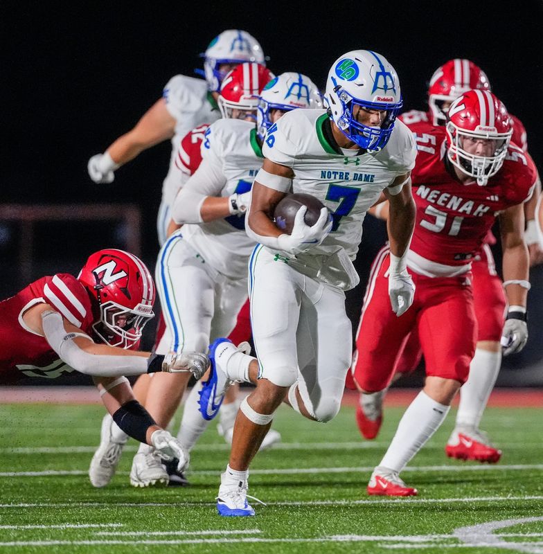 Green Bay Notre Dame's Kingston Allen (7) runs the ball against Neenah High School on Friday, Aug. 21, 2026, at Neenah High School in Neenah, Wisconsin. Notre Dame won the game in overtime, 56-53.
Tork Mason/Green Bay Press-Gazette
