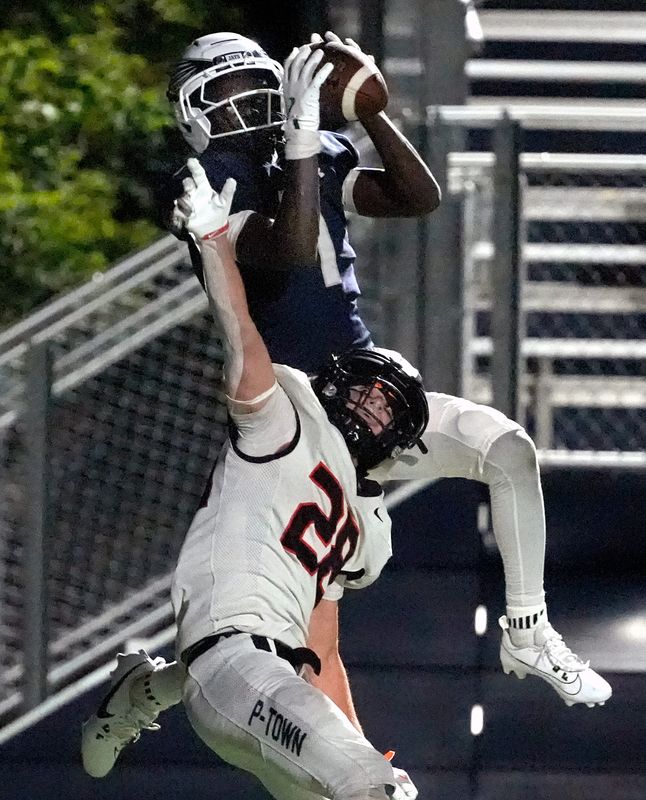 Menasha High School’s Shamir Senyange (1) catches a touchdown pass over the defense of Plymouth High School’s Gabe Gritt (5) during their football game Friday, August 21, at the Lawrence University Banta Bowl in Appleton, Wisconsin. Plymouth defeated Menasha 42-41.
Wm. Glasheen USA TODAY NETWORK-Wisconsin