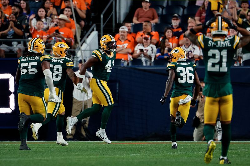 Aug 21, 2026; Denver, Colorado, USA; Green Bay Packers safety Mark Perry (41) reacts with linebacker Isaiah McDuffie (58) and defensive tackle Chris McClellan (55) and cornerback Kamal Hadden (36) after an interception in the second quarter against the Denver Broncos at Empower Field at Mile High. Mandatory Credit: Isaiah J. Downing-Imagn Images