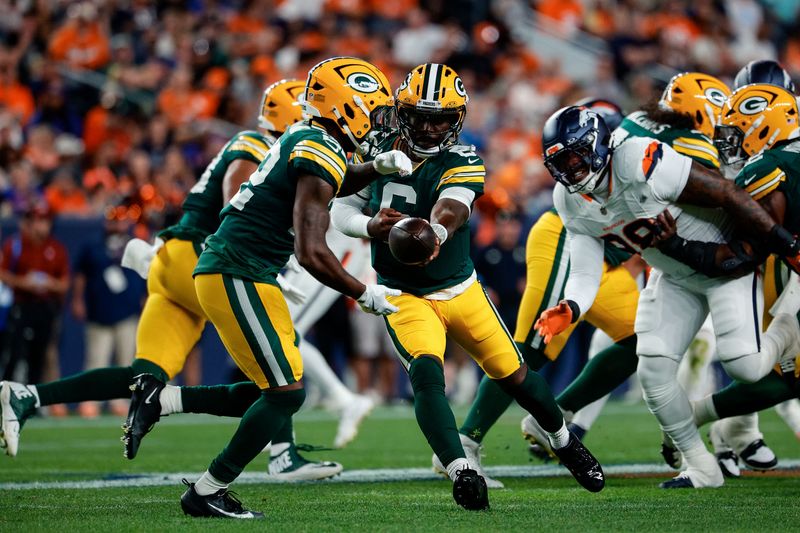 Aug 21, 2026; Denver, Colorado, USA; Green Bay Packers quarterback Tyrod Taylor (6) hands the ball off to running back Pierre Strong Jr. (22) in the second quarter against the Denver Broncos at Empower Field at Mile High. Mandatory Credit: Isaiah J. Downing-Imagn Images